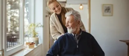 Close up of a granddaughter helping her grandfather around the house