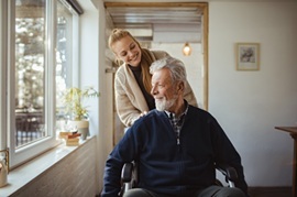 Close up of a granddaughter helping her grandfather around the house